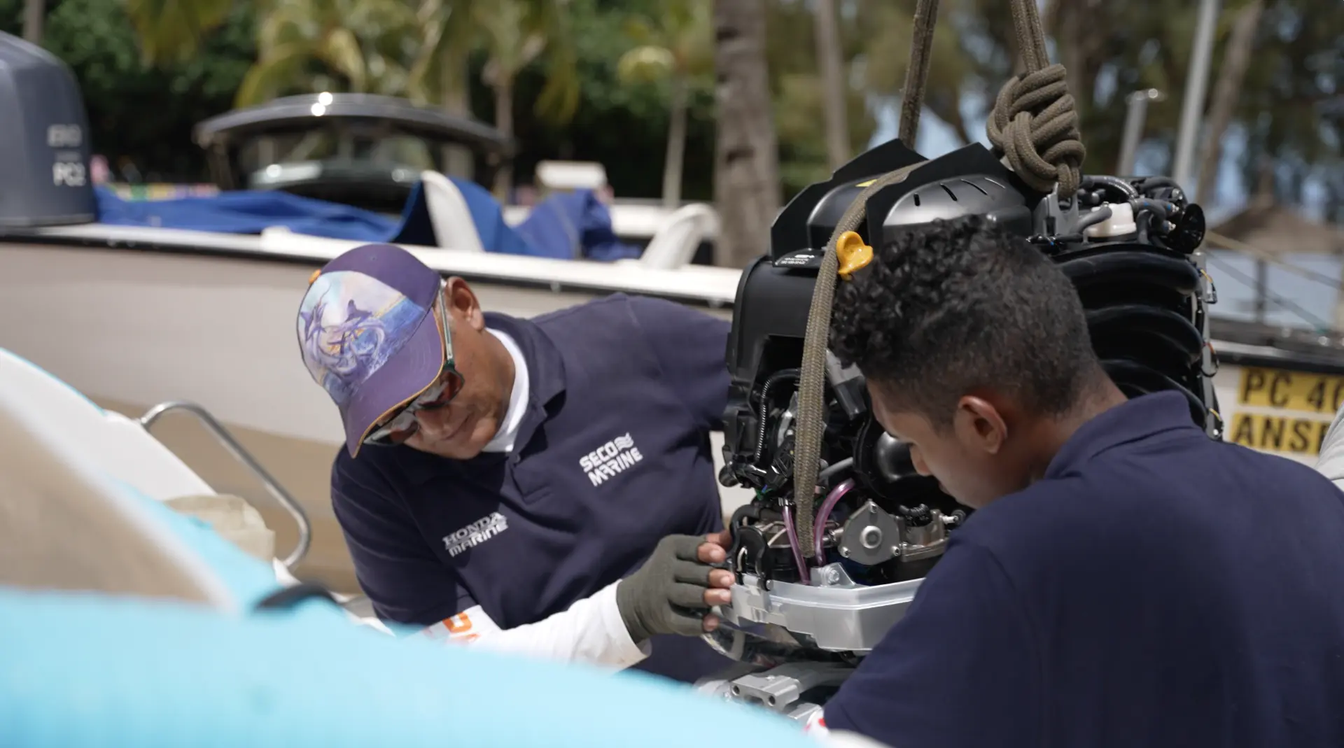 SECO Marine technicians working on a Honda outboard engine