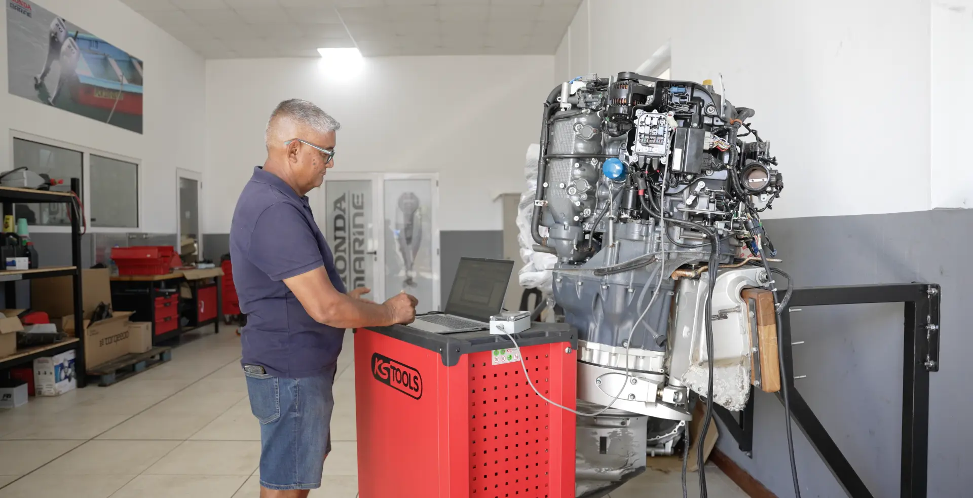SECO Marine technician running diagnostics on an outboard engine