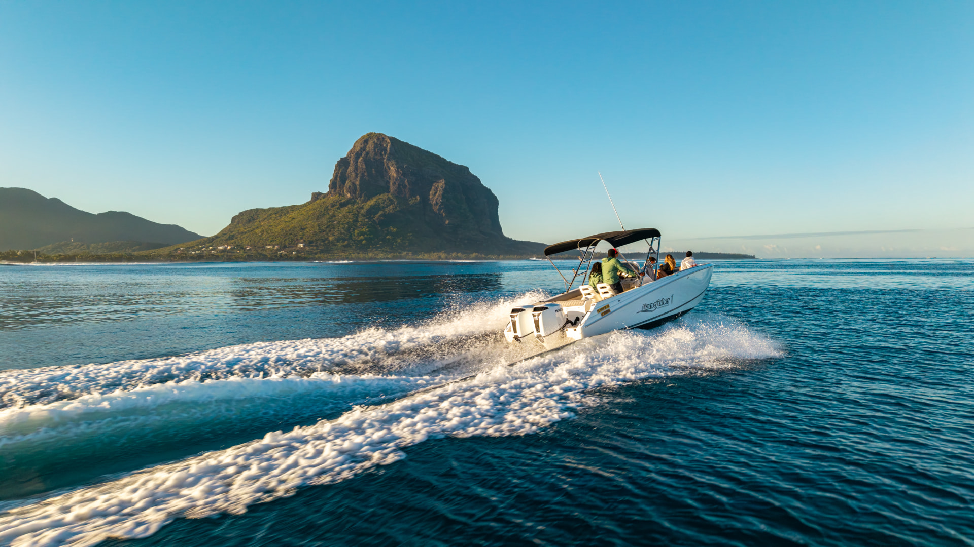 Premium motor yacht cruising the turquoise lagoon of Mauritius