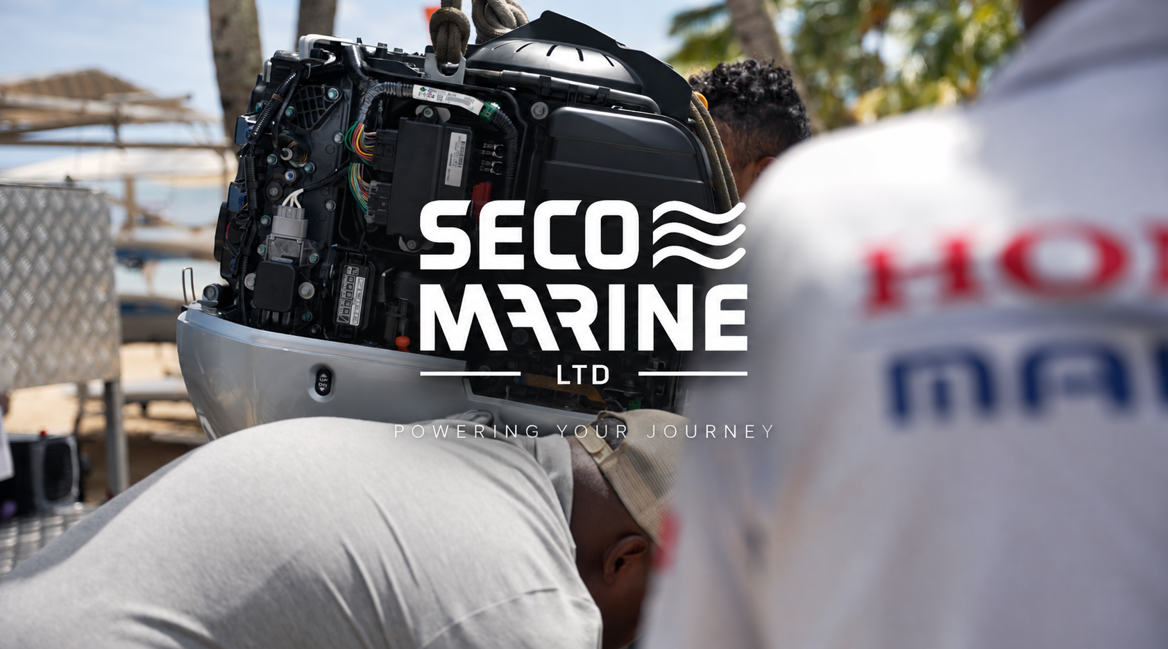 SECO Marine technicians servicing an outboard engine in the workshop